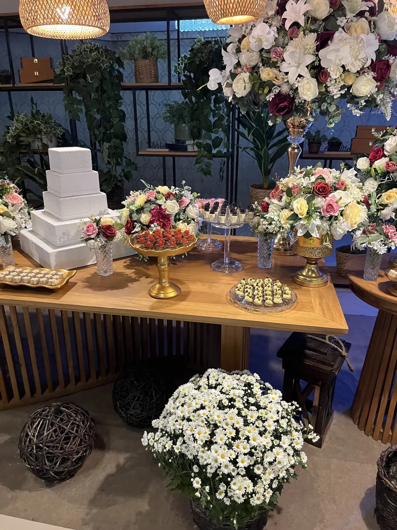 Mesa de doces de casamento da AuraDocesFinos com bolo de andares e arranjos florais